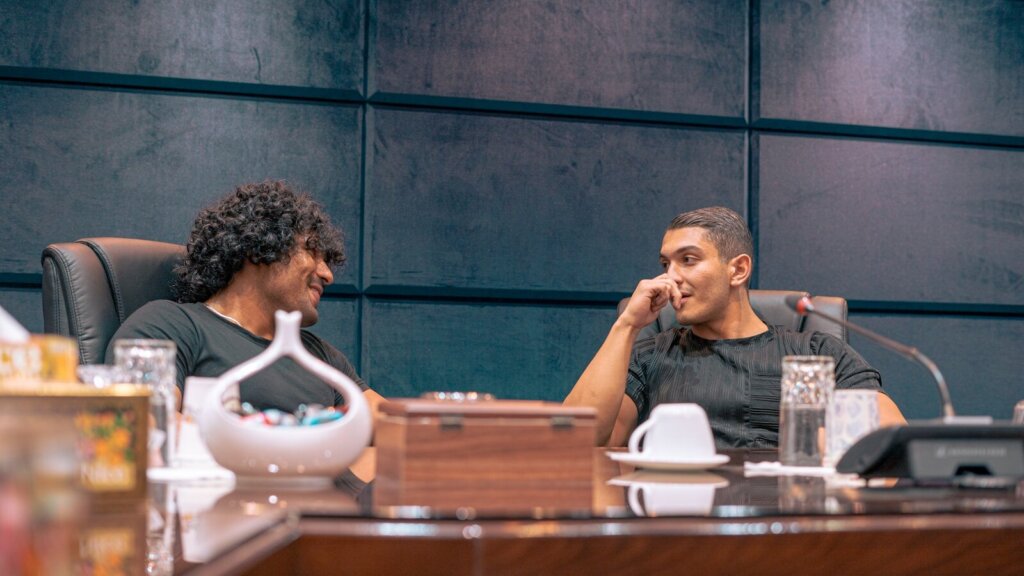 a couple of men sitting at a table