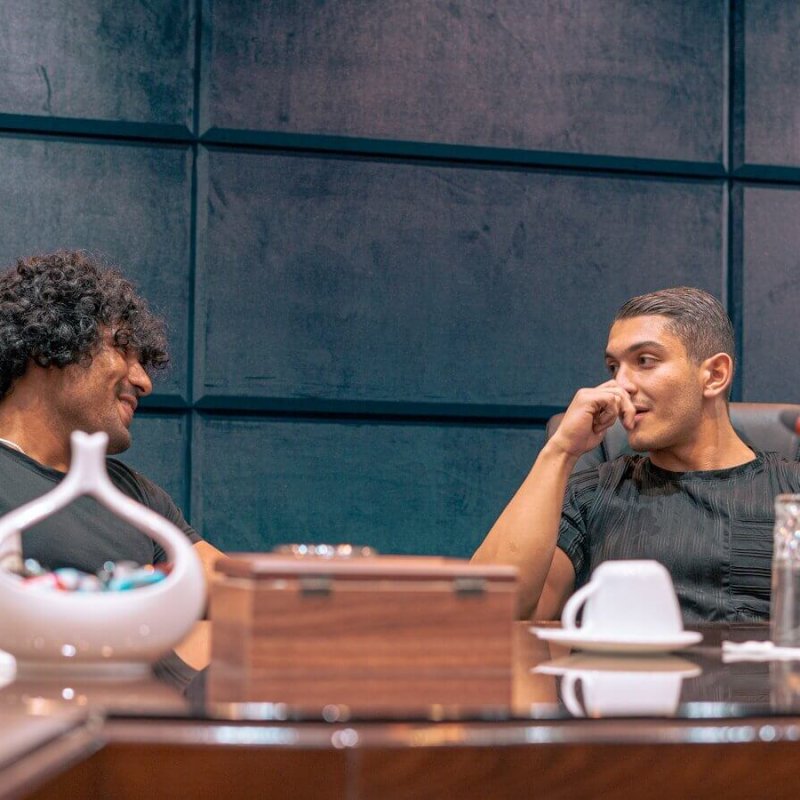 a couple of men sitting at a table