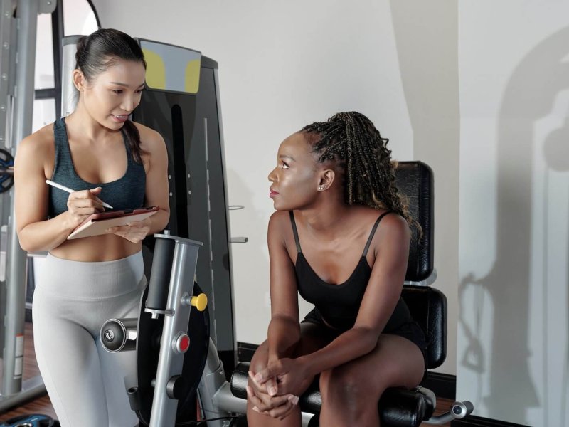 woman-listening-to-recommendations-of-fitness-trainer.jpg
